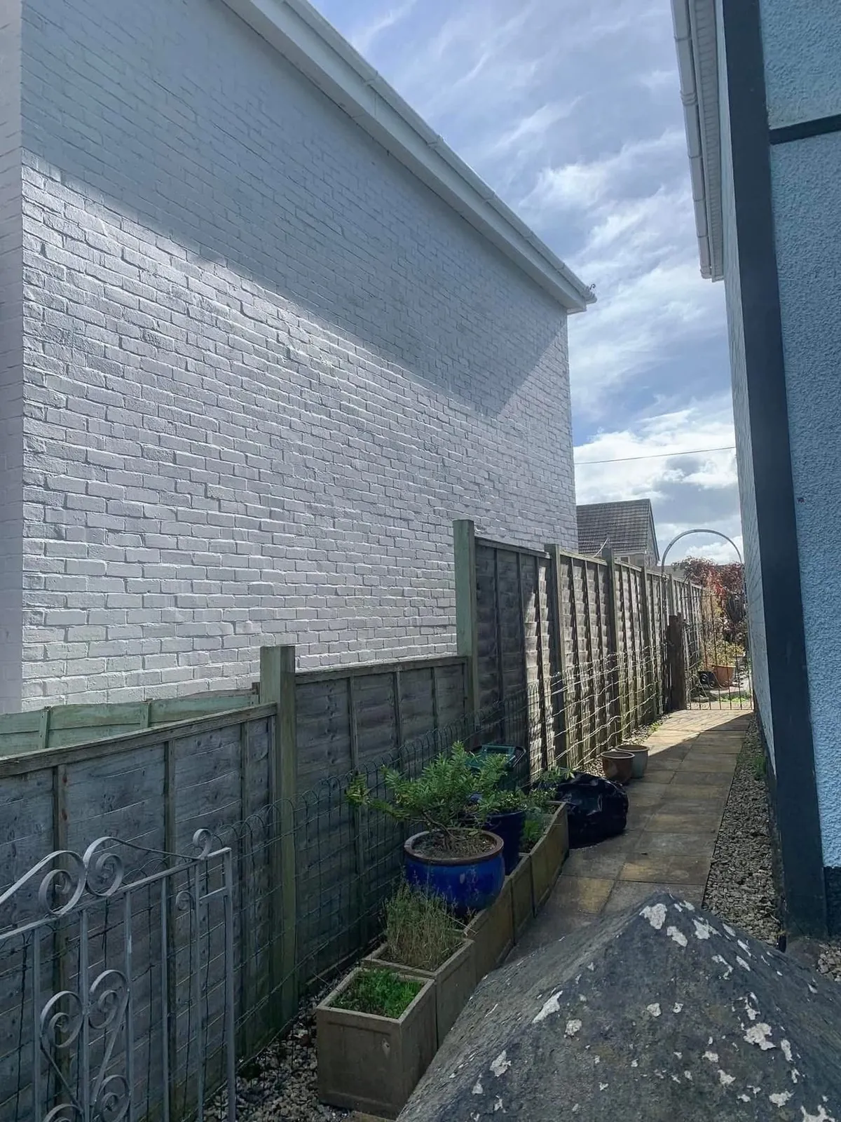 Freshly painted brick wall after preparation and masonry paint in Marazion